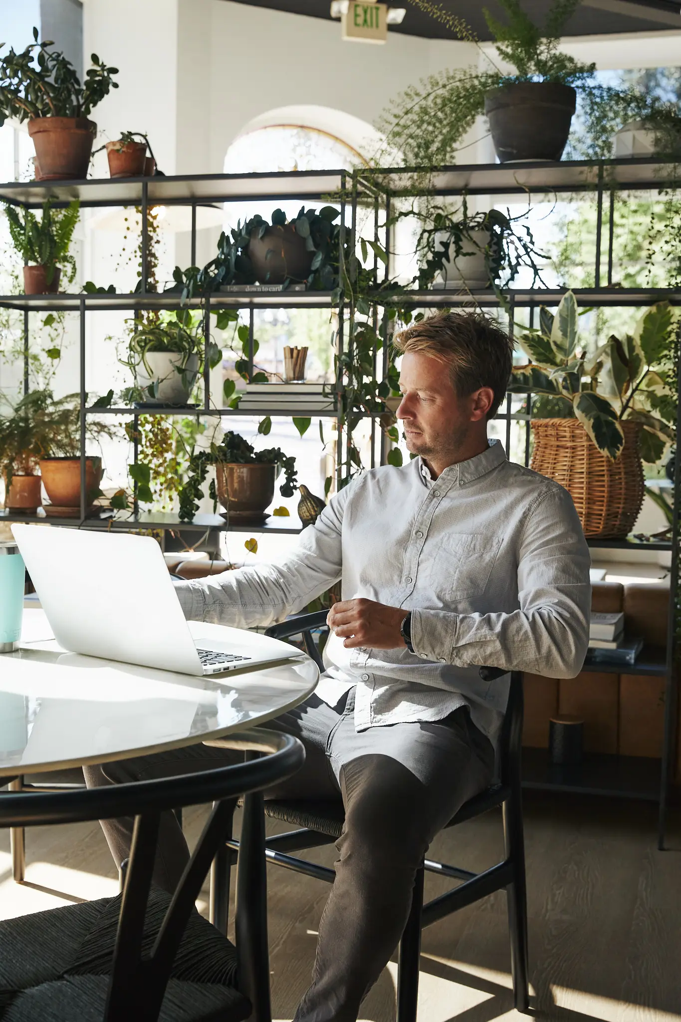Derek Buse at the meeting table by the office windows